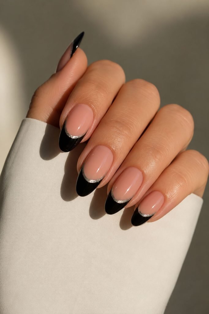 Black French manicure with delicate silver accents creating a modern and luxurious nail design