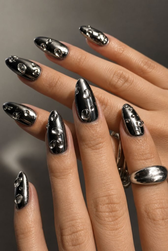Black chrome nails with glossy mirror finish and realistic 3D water drop nail art details