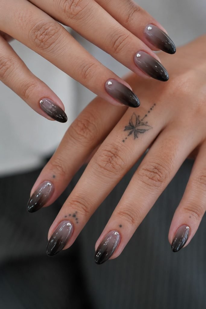Black ombre nail designs blending deep black into soft smoky gray for a chic gradient manicure