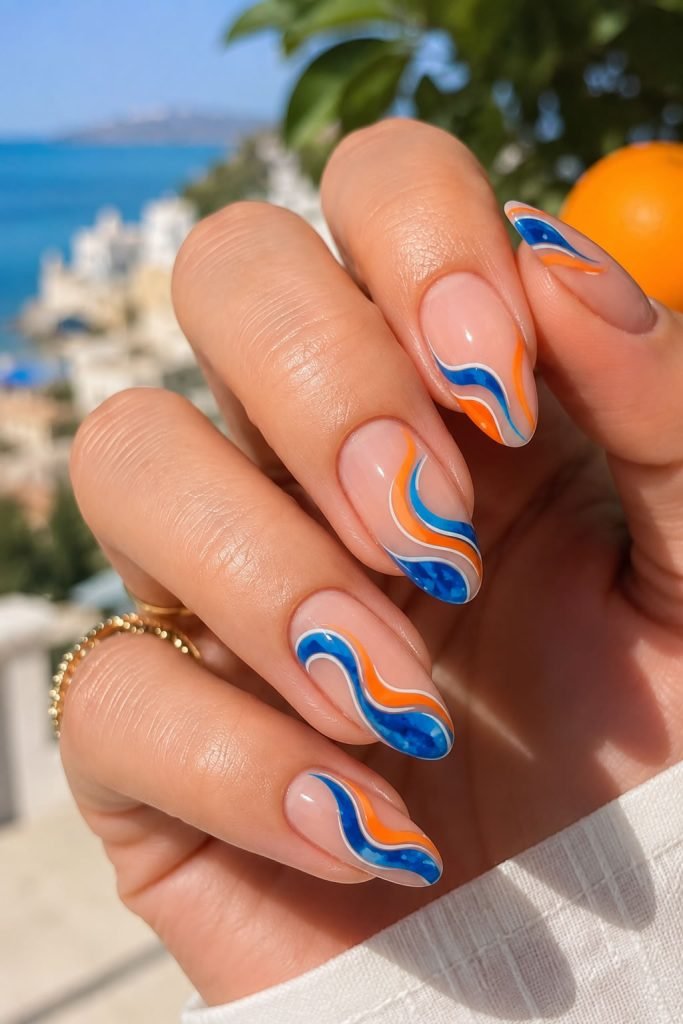 Blue and orange summer nails with bold colorful nail designs for vacation style