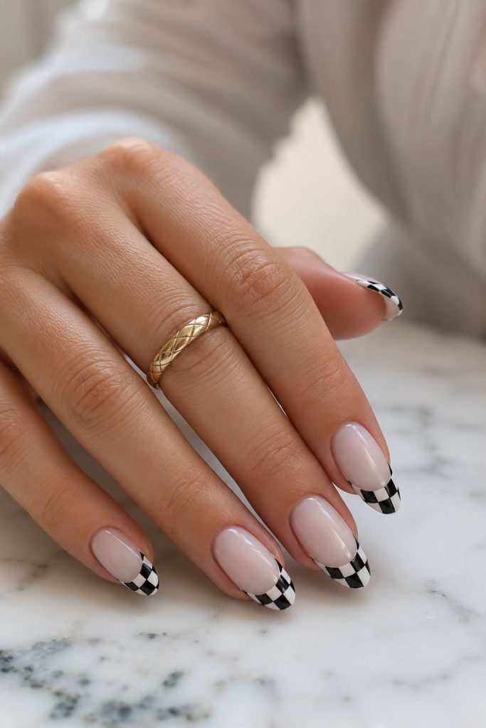 Checkmate black and white checkerboard French tip nails with modern geometric nail art