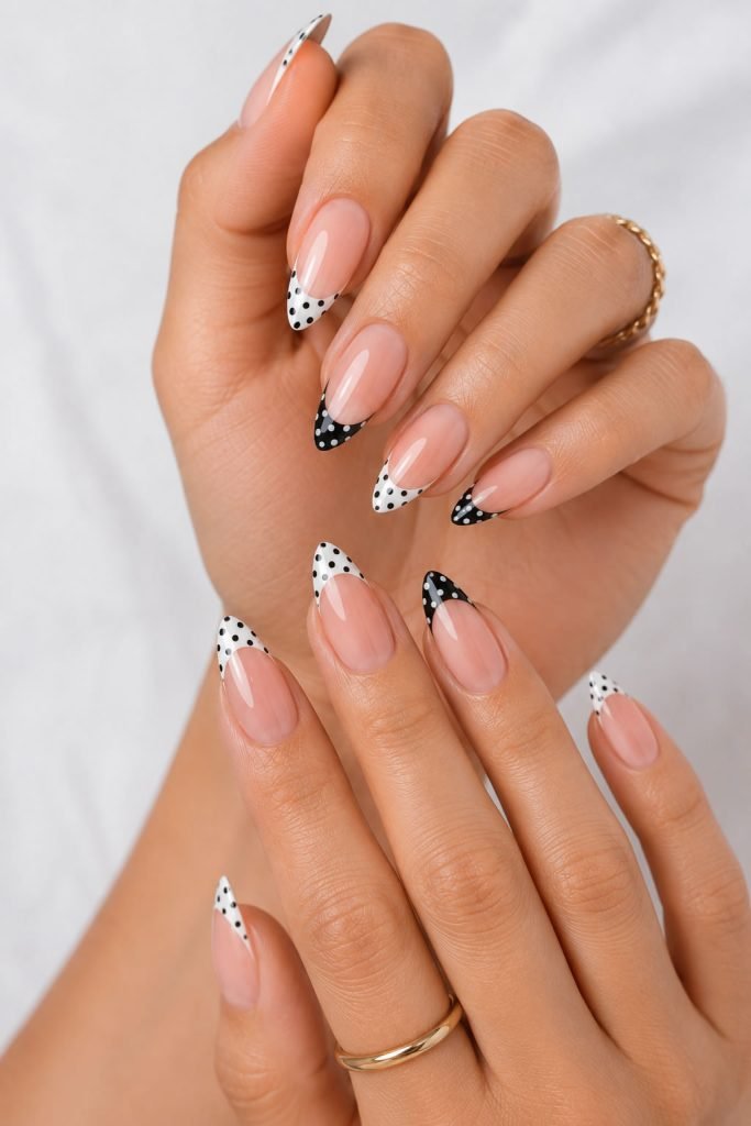 Spotted French tip almond nail designs with trendy polka dot accents