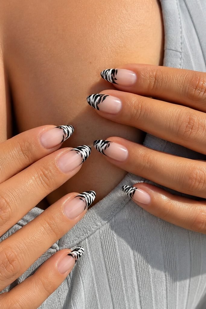 Zebra print black and white French tip nails with trendy monochrome animal print nail art