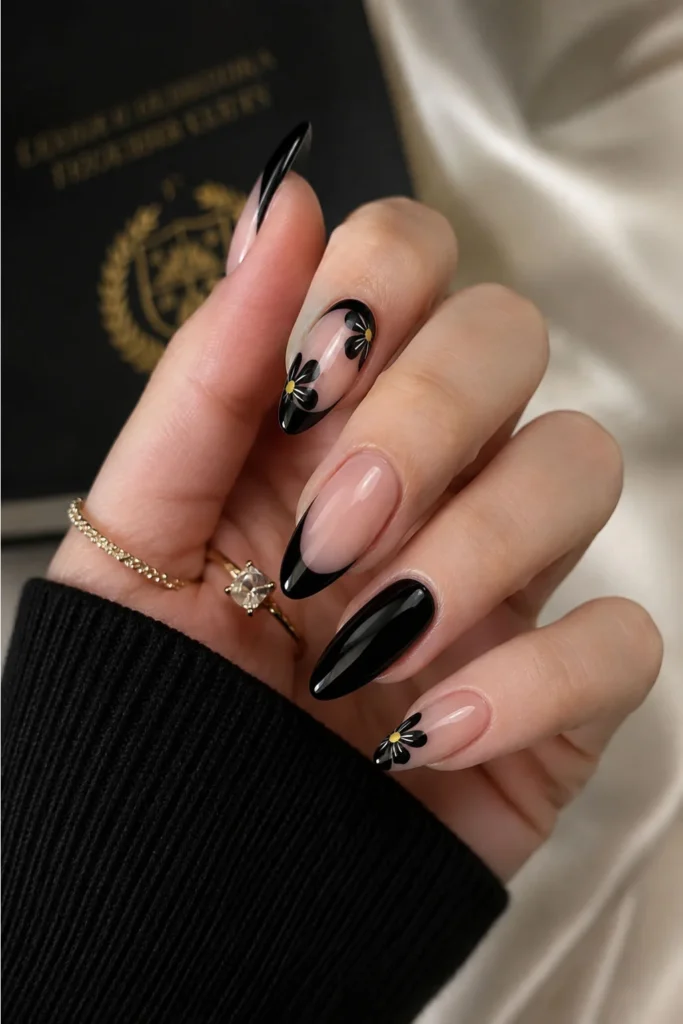 Black French tip graduation nails with delicate daisy accent nail art
