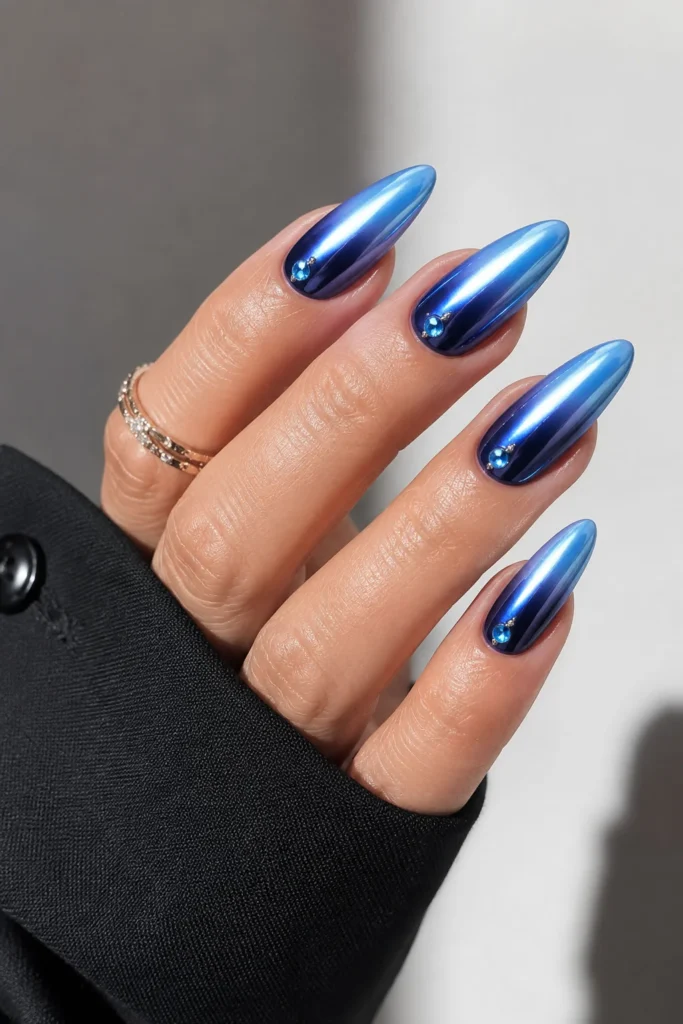 Blue chrome ombre graduation nails with a reflective almond-shaped finish