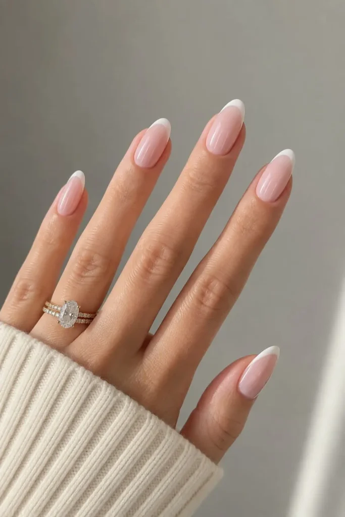 Classic French Tip nails with soft white tips and pink base