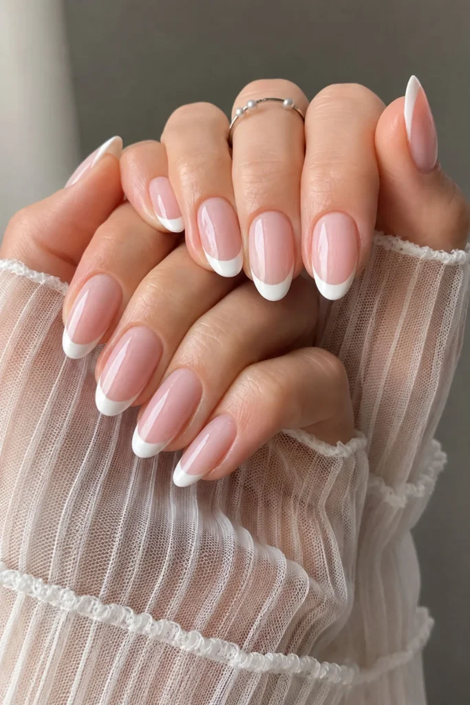 Classic white French tip graduation nails with a sheer pink base