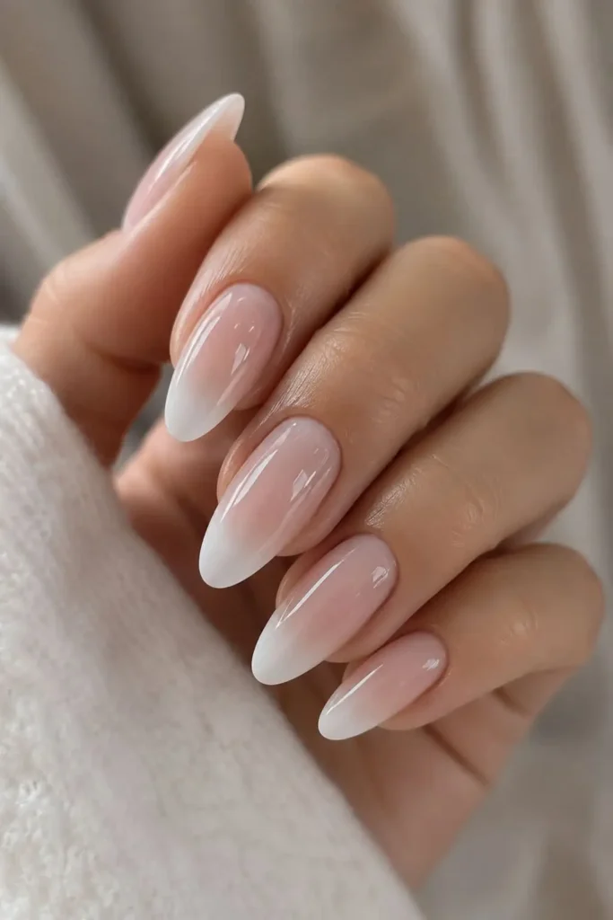 Faded white ombre French tip nails with a sheer nude base