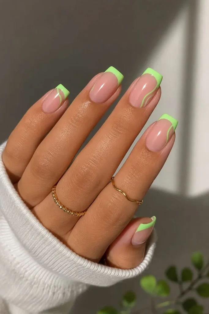 Fluorescent French gel nails with bright neon green tips and a glossy nude base