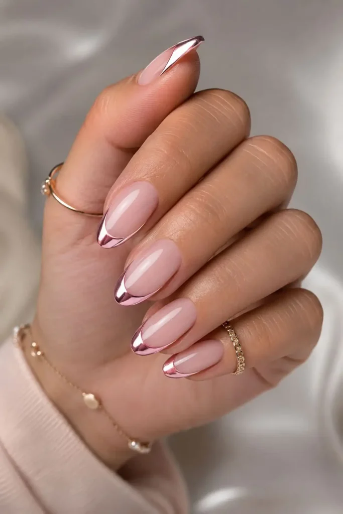 Pink chrome French tip almond nails with a milky nude base