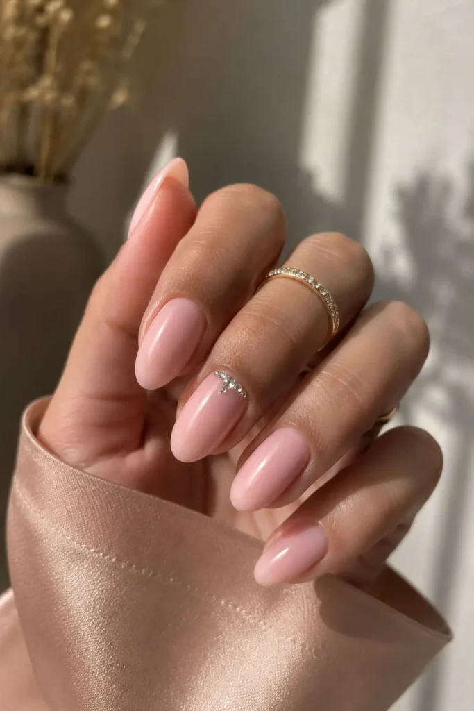 Pink satin nude nails with a soft milky sheer blush-pink finish