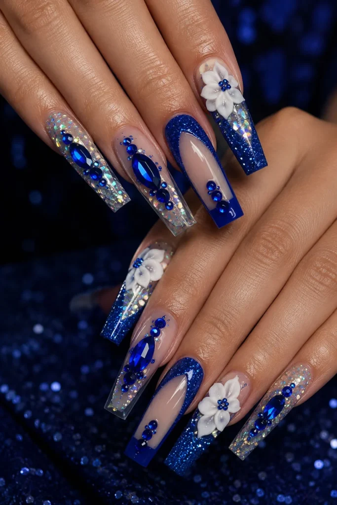 Royal blue graduation nails with rhinestones, glitter and 3D flower accents