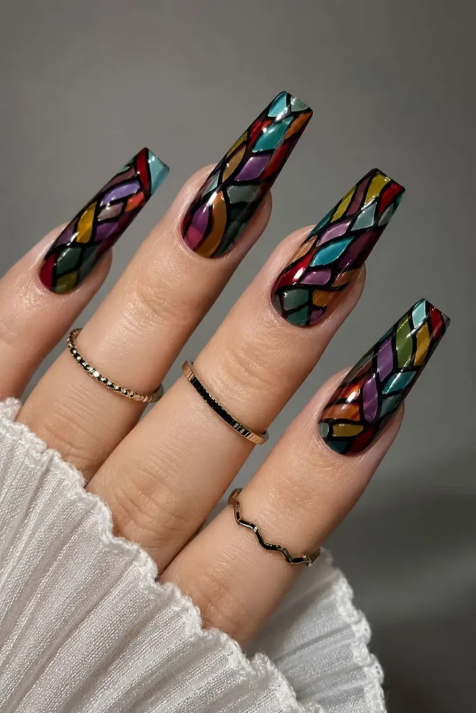 Stained glass coffin nail design with colorful jewel-toned panels