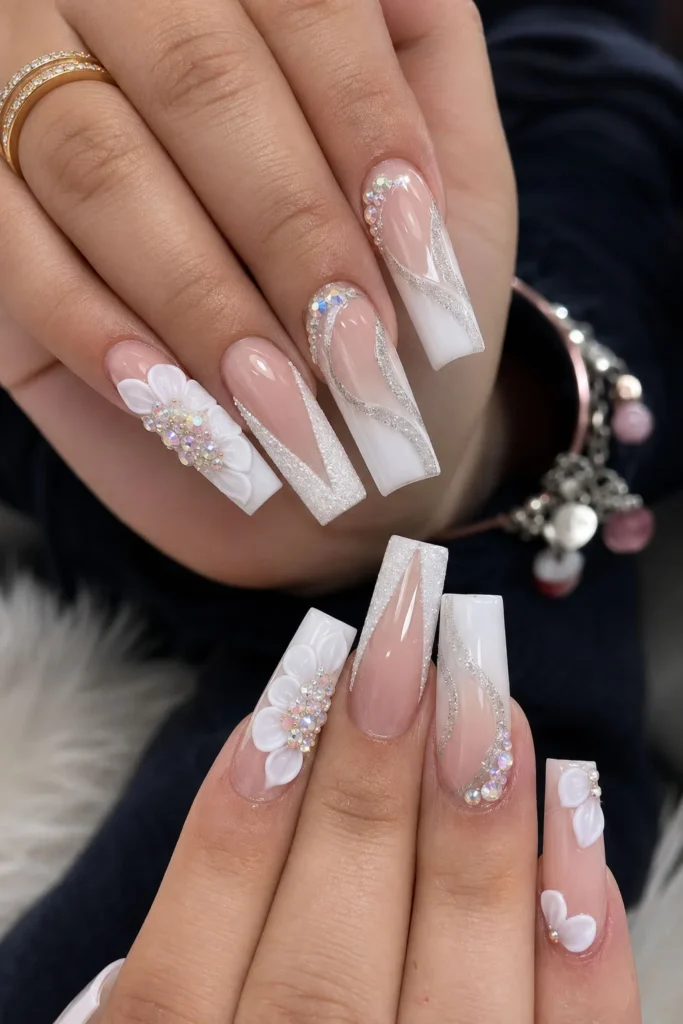 White coffin graduation nails with 3D flowers, rhinestones and silver accents