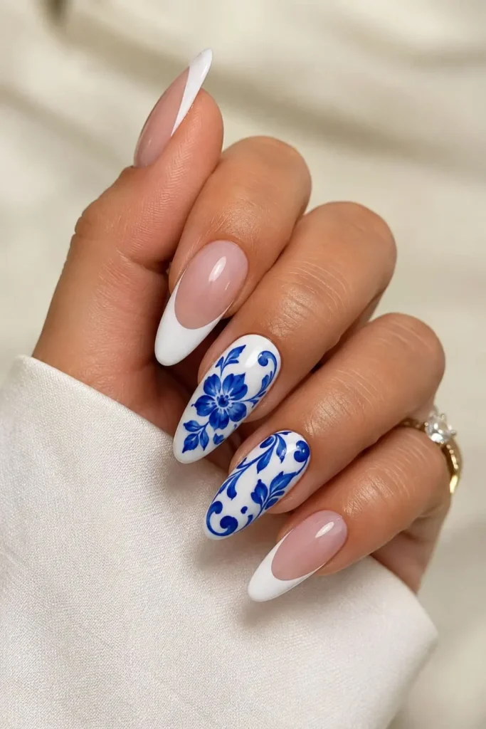 White French tip nails with royal blue accent nail art