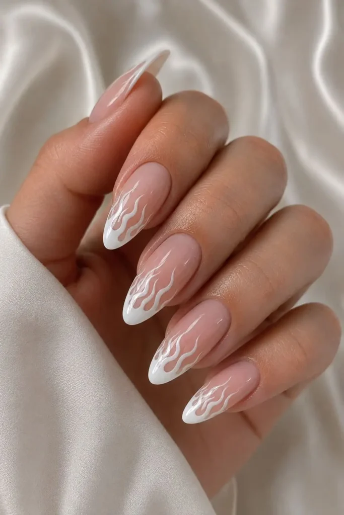 White flame French tip nails with pointed flame nail art
