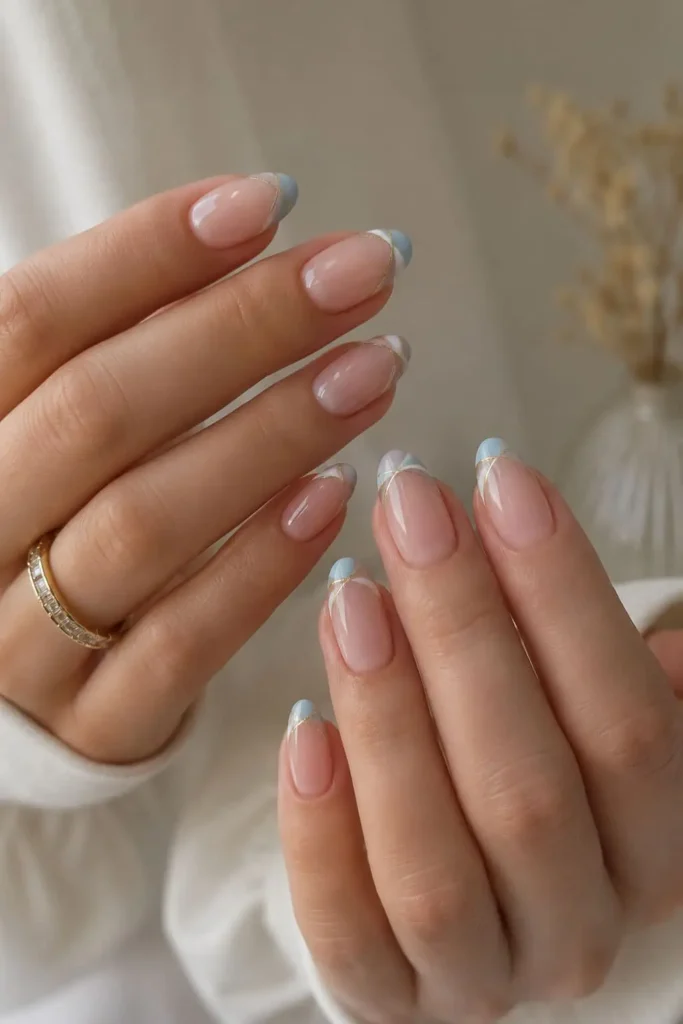 Glassy bridal nail tips with subtle gold and cat-eye details