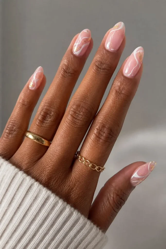 glittery white swirls and gold splotches nails