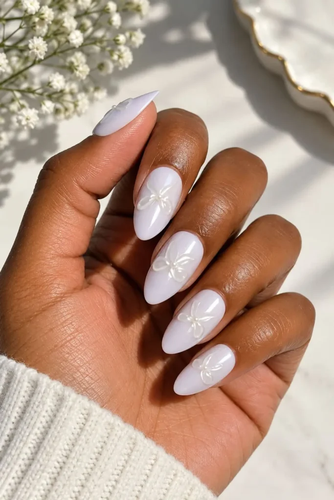 3D lilac coquette bow nails with soft pastel sunset-inspired colors
