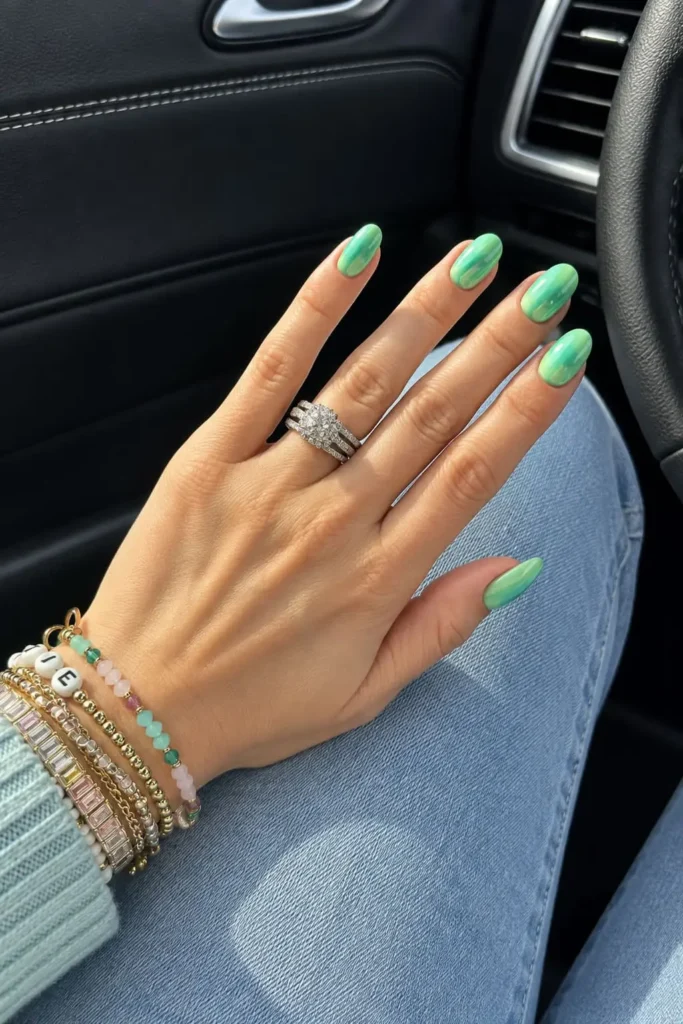 Short square nails with shimmering aquamarine green and blue metallic tones