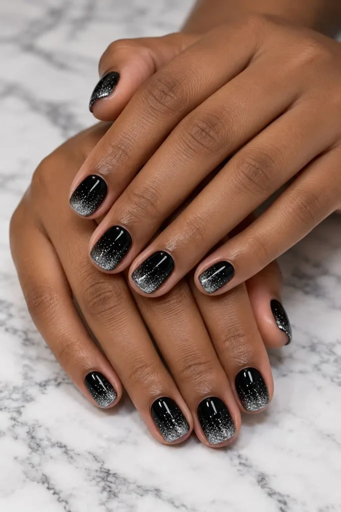Black and silver ombré gel nail design with shimmering tips