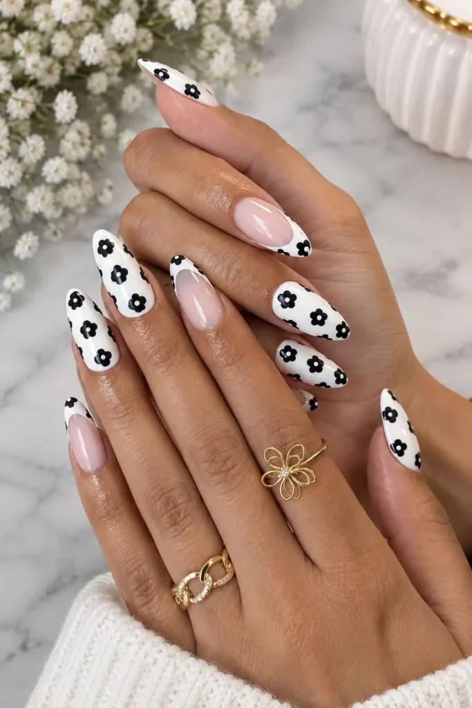 Black and white floral nails with delicate black flowers on a white base