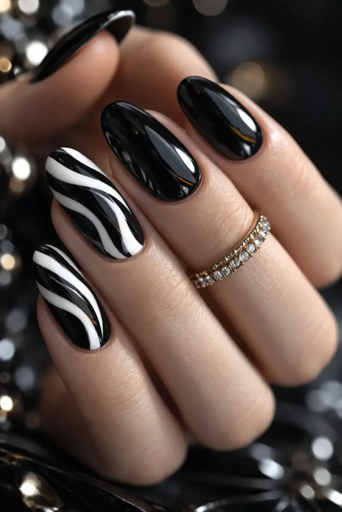 Black and white long acrylic nails with intricate white line art on a black base