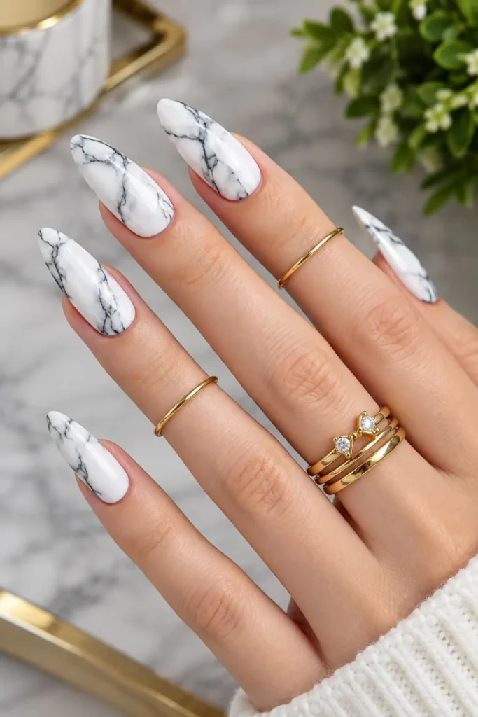 Elegant black and white marble nails with delicate veined patterns
