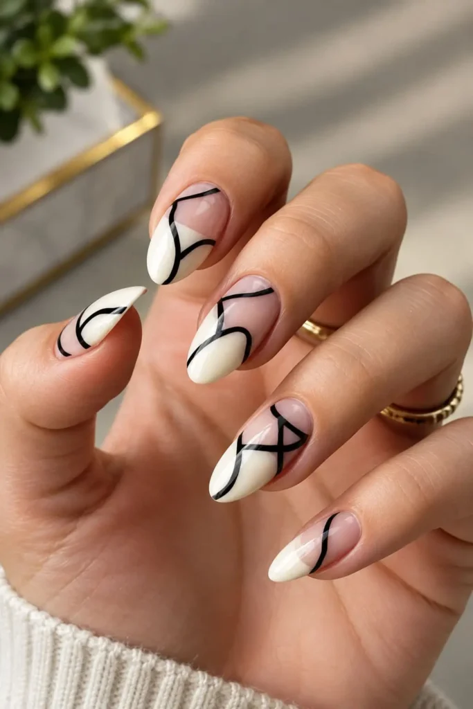 Black and white negative space nails with minimalist geometric accents