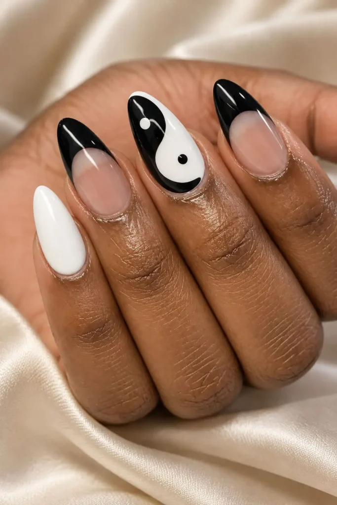 Black and white yin and yang nail art with curved contrasting details