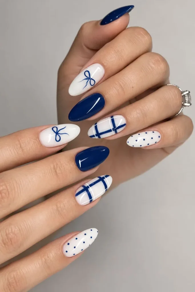 Blue and milky white coquette bow nails with winter-inspired accents