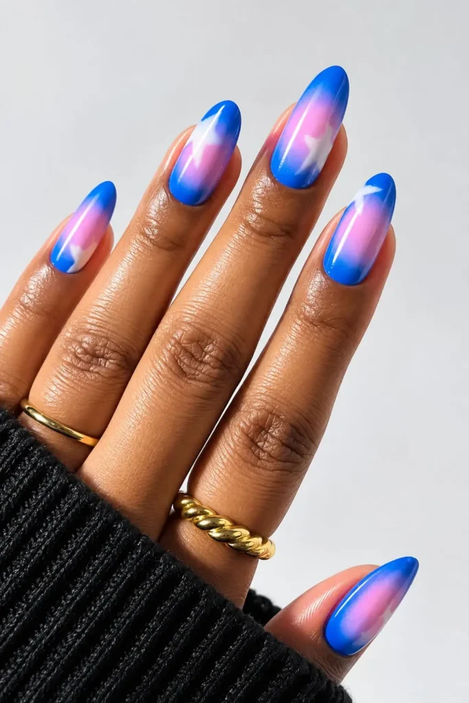 Blue aura nails with dark blue and black tones finished with a glossy shine