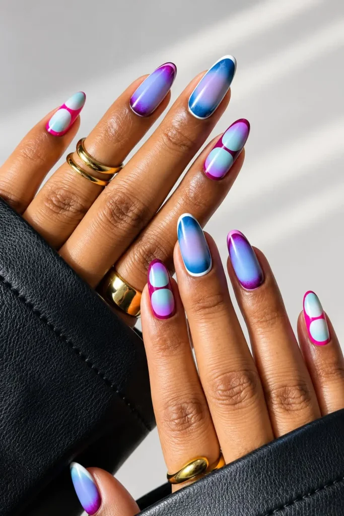 Blue and purple aura nails with bright blue, purple and pink glowing color blends