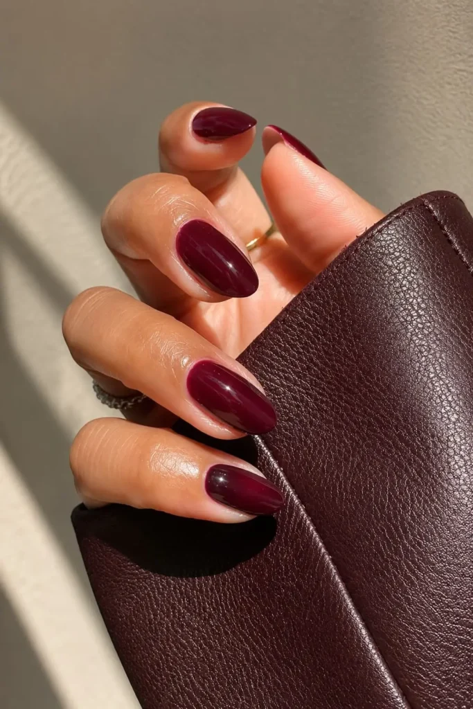 Burgundy almond nails with a glossy deep red finish on almond-shaped nails
