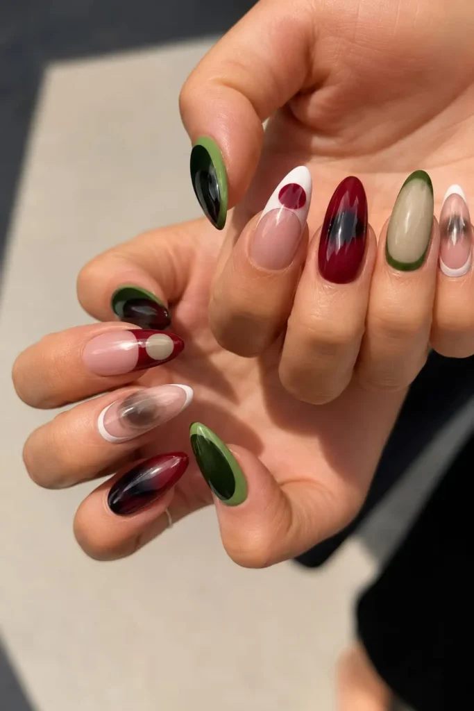 Burgundy and green aura nails with a moody blended color effect