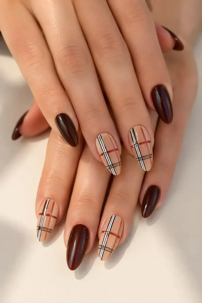 Burgundy plaid nails featuring thin crosshatch lines and a classic fall pattern
