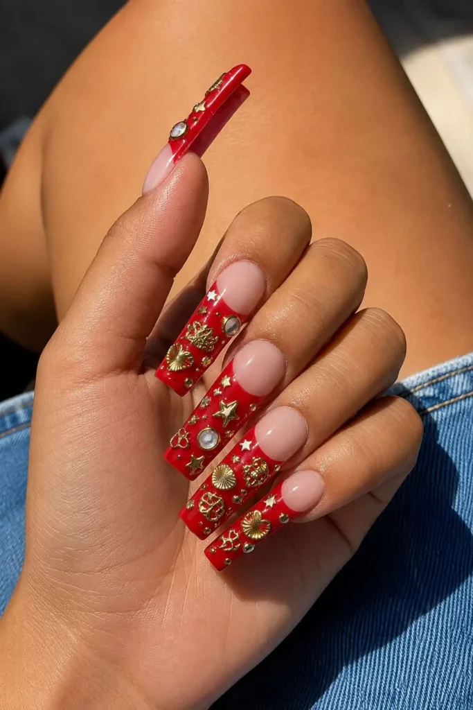 Charm-filled French tips with delicate embellishments on a sheer base
