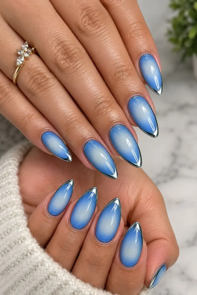 Chrome aura nails with a silvery metallic base and holographic glowing center