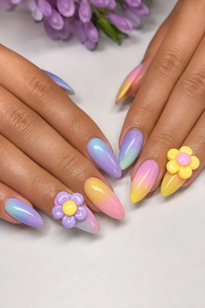 Floral charm nails with colorful flower accents on a pastel manicure