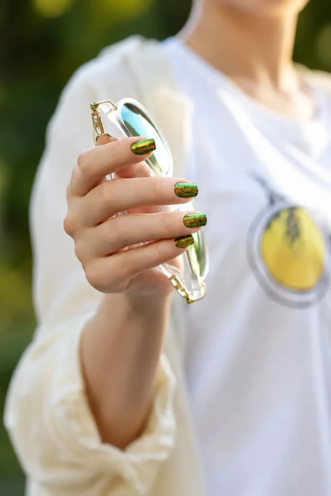 dark forest green cat eye nails with gold shimmer