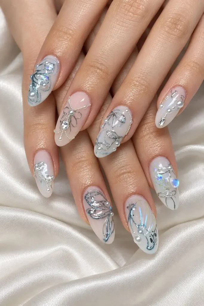 Nude winter nails with pearls, silver details, and elegant coquette bows