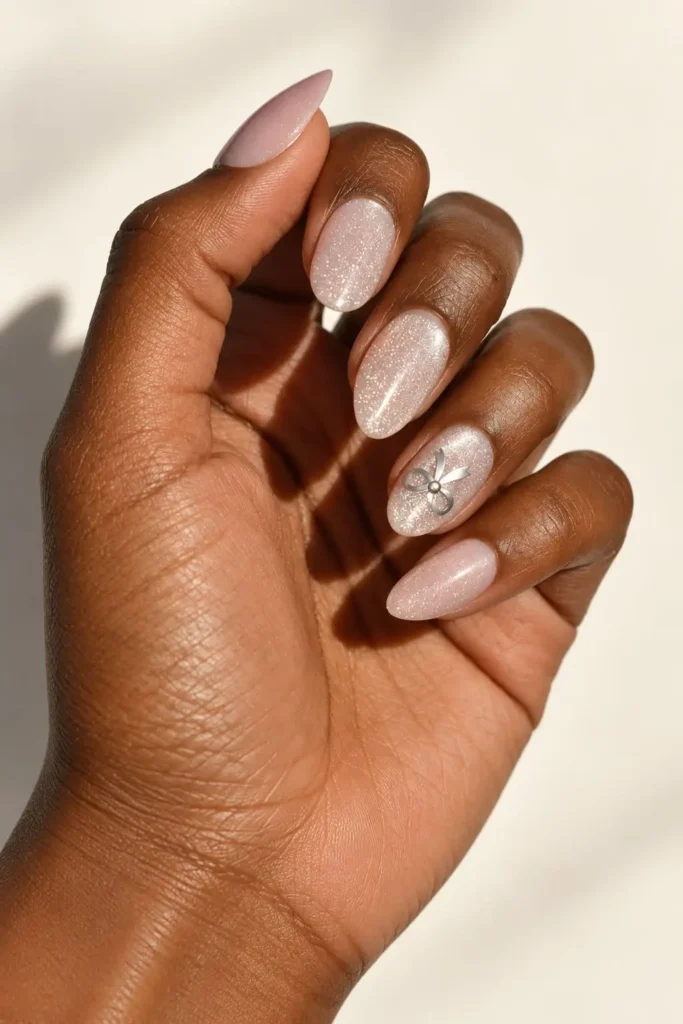 Glittery pink coquette bow nails with a sparkling feminine finish