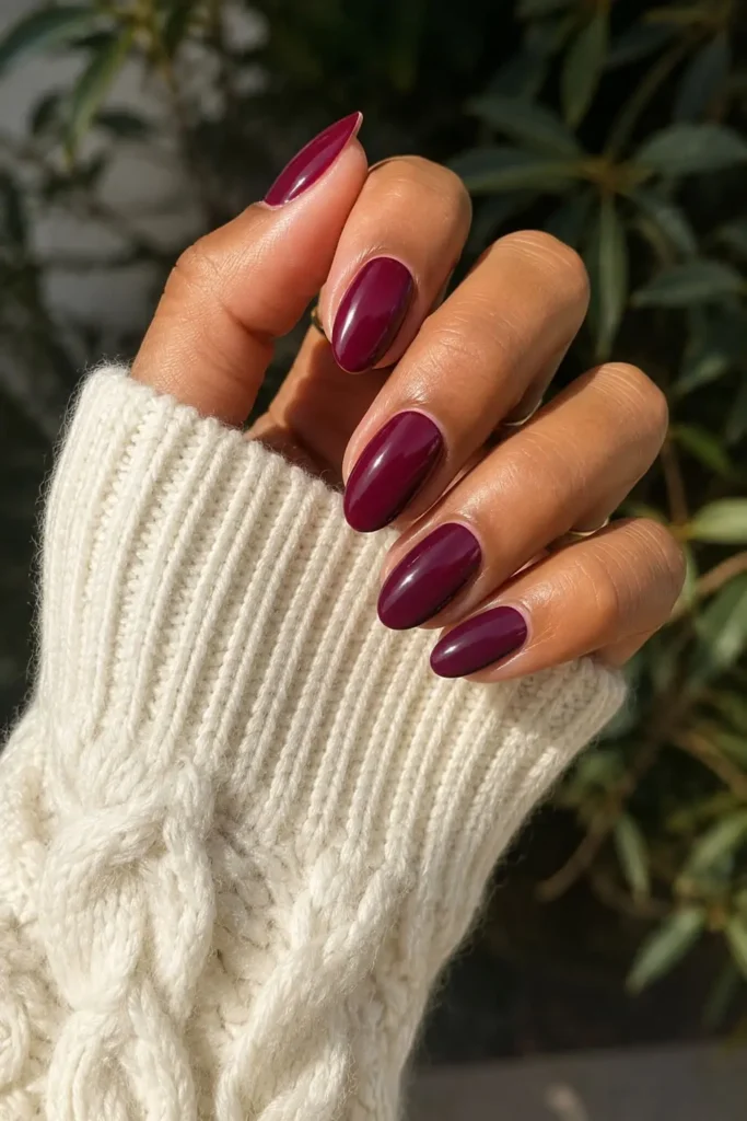 High-shine burgundy manicure with glossy dark red polish