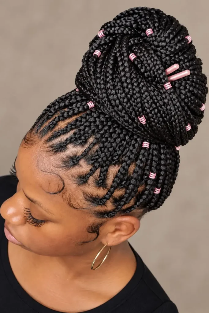 Knotless braids gathered into a polished low-bulk bun