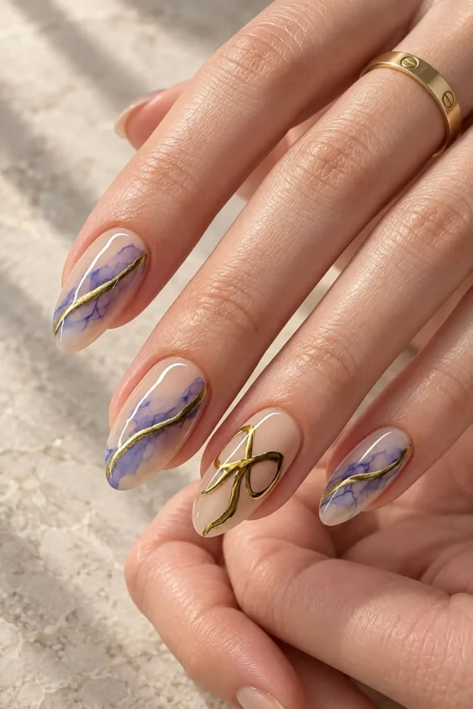 Lavender and nude coquette nails with delicate gold bow accents