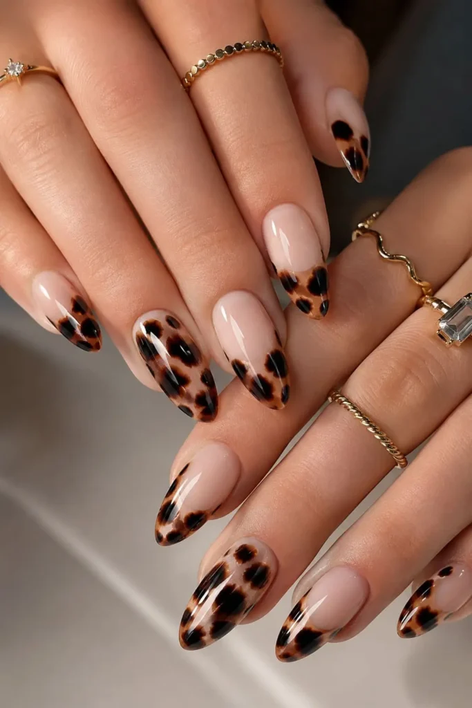 leopard print cat eye nails with black spots and glassy shimmer