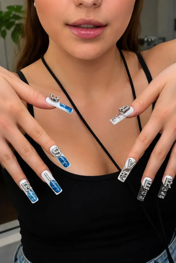 Lettered charm nails featuring rhinestone alphabet accents on one nail