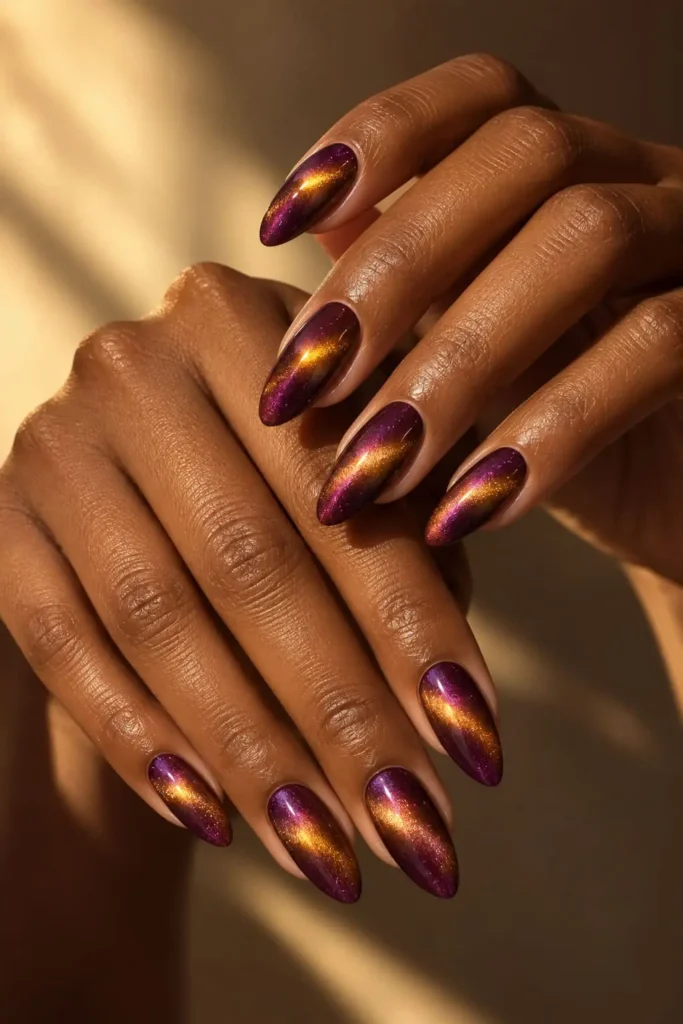 Eggplant magnetized marble gel nails with shimmering gold accents