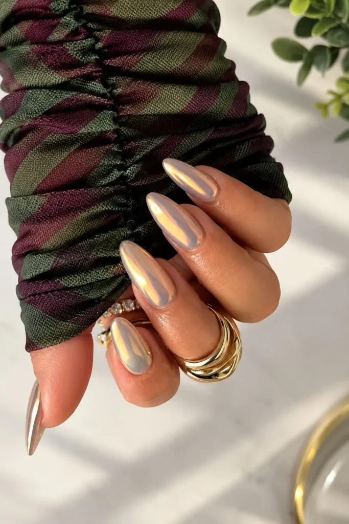Nude chrome gel nails with a subtle glossy metallic finish