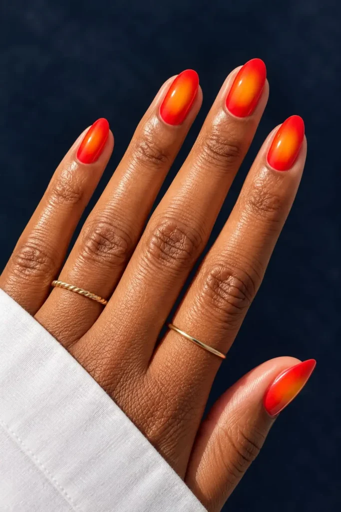 Orange aura nails with bright citrus tones and a soft glowing center gradient